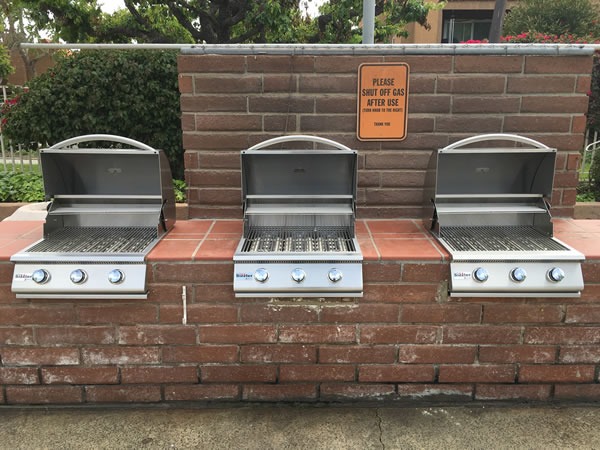 Freshly cleaned stainless steel gas grill on a sunny Southern California patio